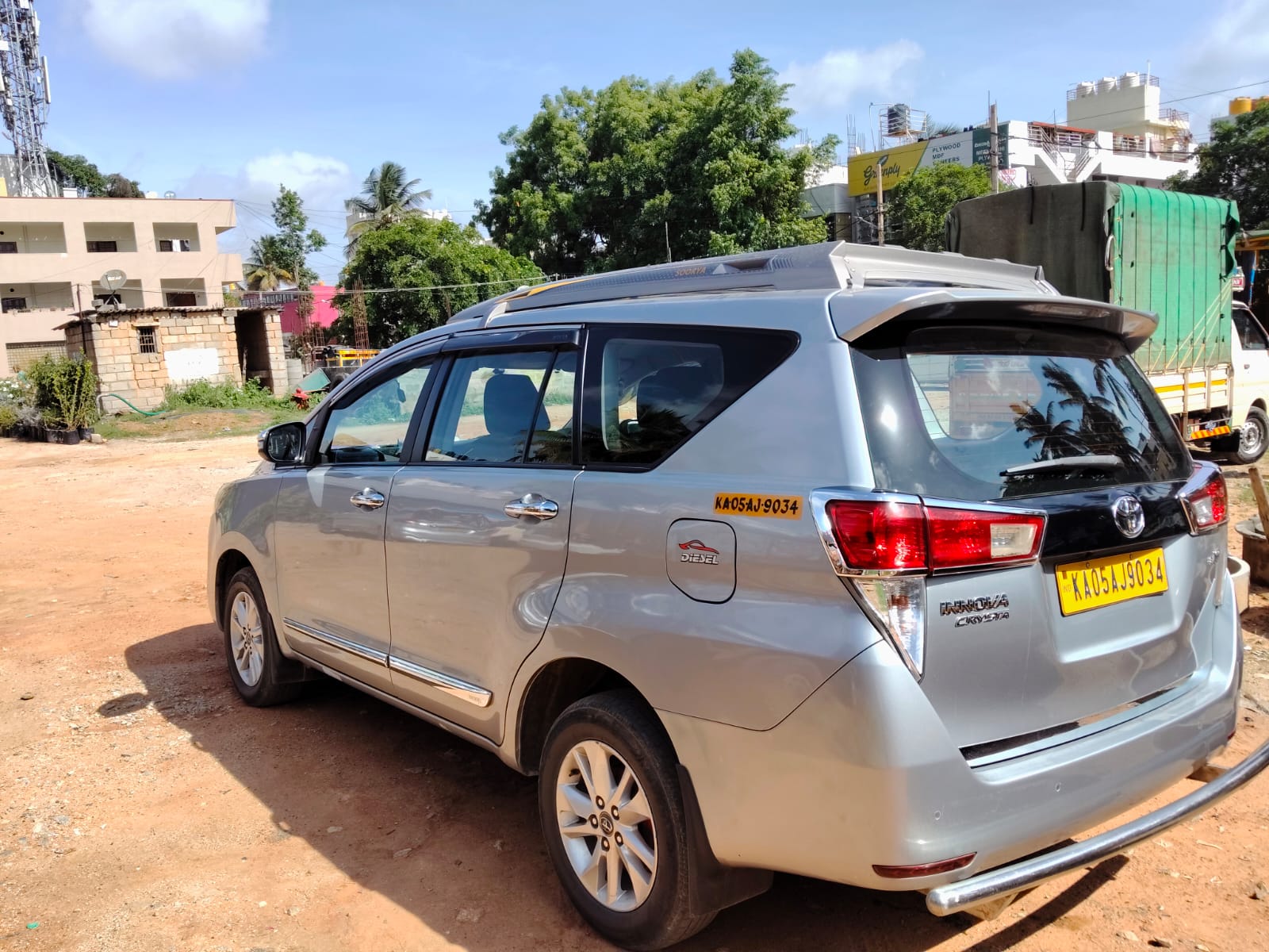 Innova Hycross parked under trees