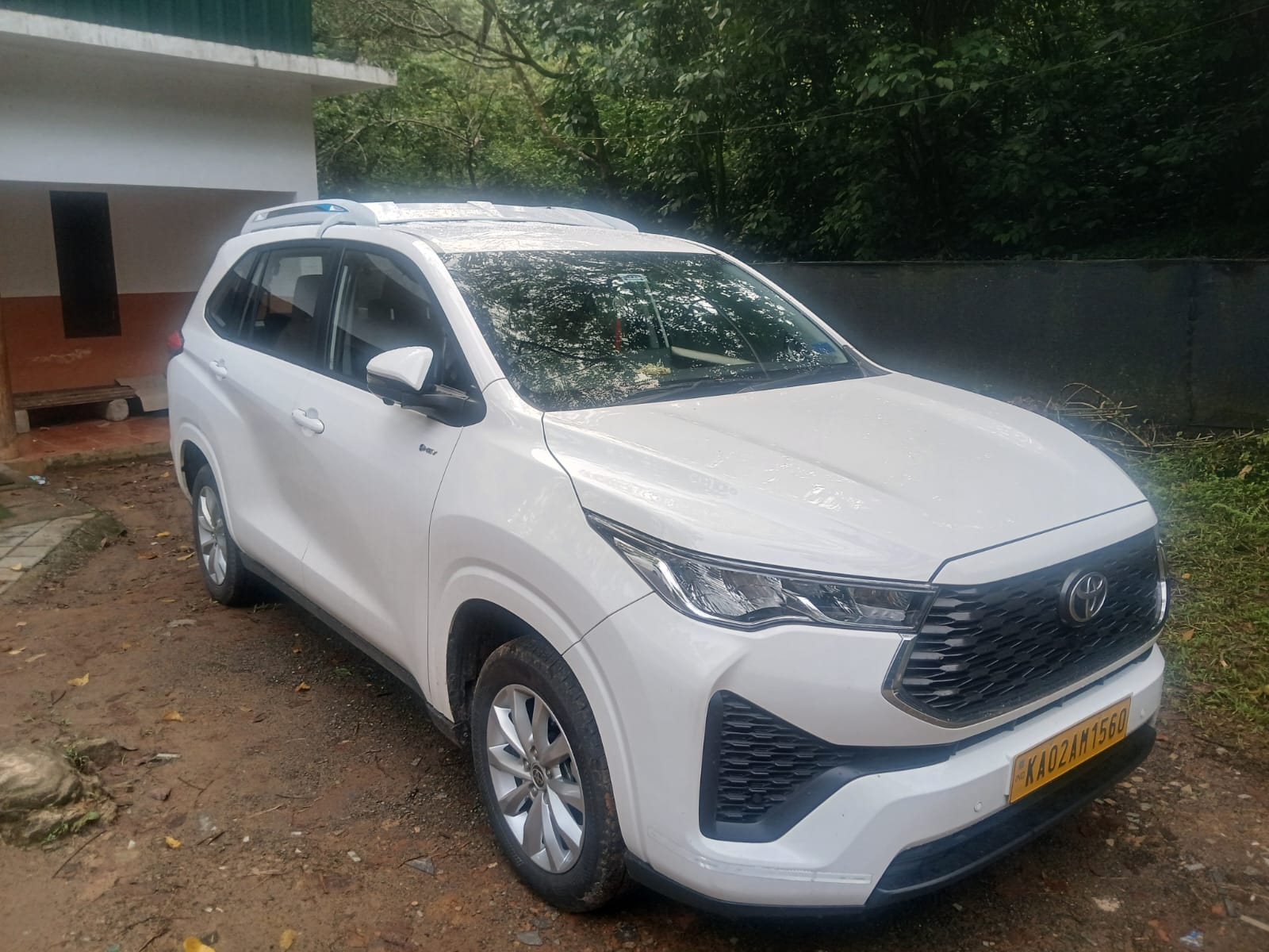 White Toyota Innova Hycross parked at a scenic location